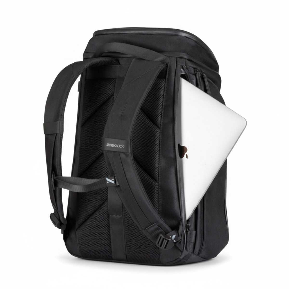 Black backpack with a silver laptop partially inserted into the laptop compartment.