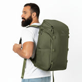 Man wearing a green backpack.