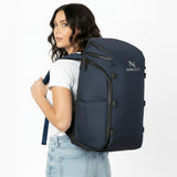 Woman wearing a navy blue backpack.