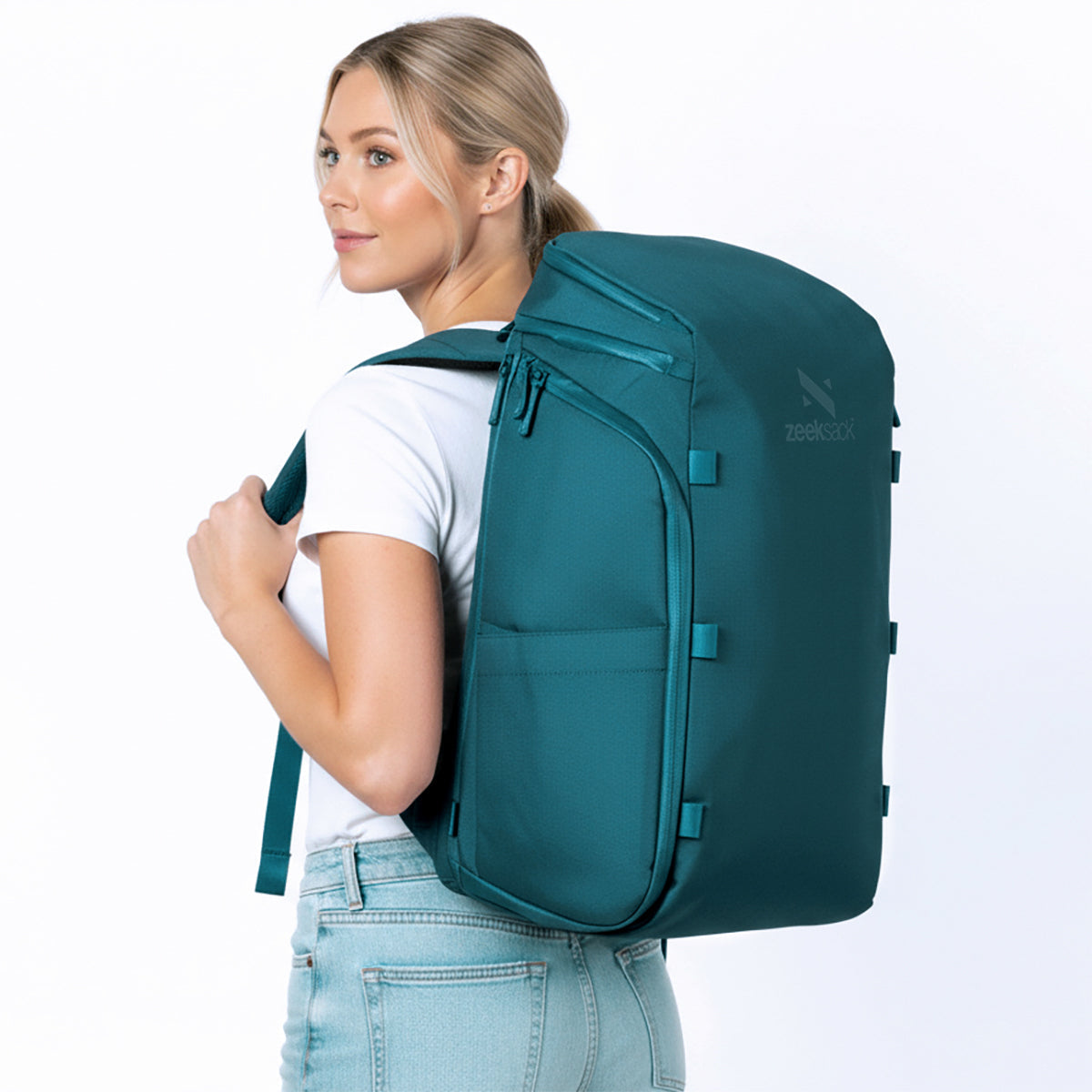 Woman wearing a petrol blue backpack.